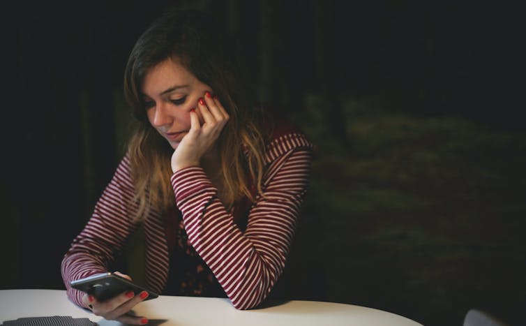 Woman looks at phone