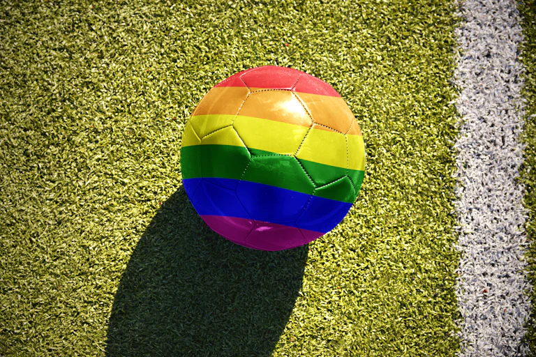 A football in rainbow colours on a pitch