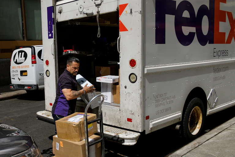 A FedEx delivery driver unloads packages from his truck in Lower Manhattan.