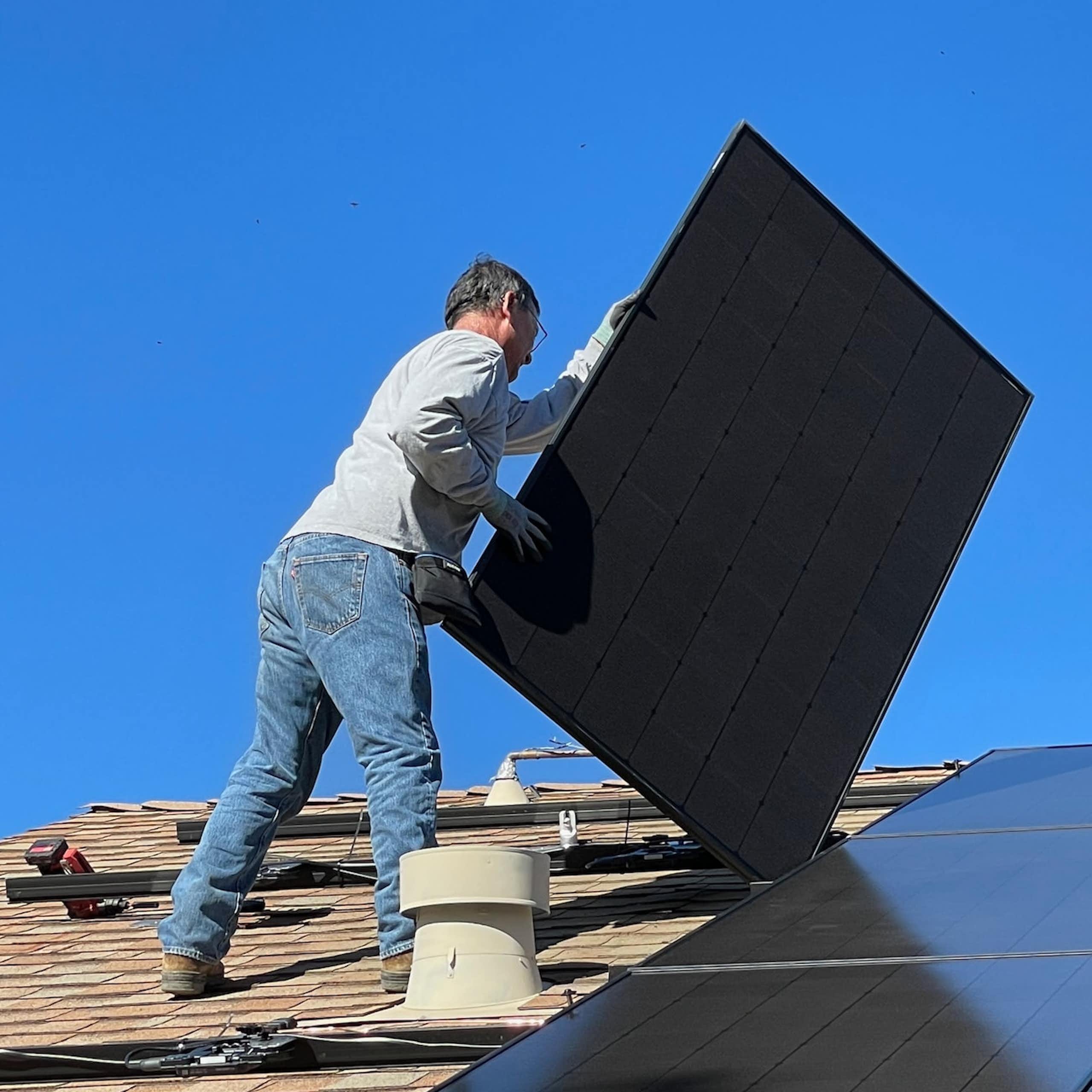 Man installing rooftop solar panels