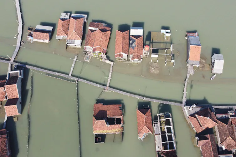 An aerial photograph of a flooded village.