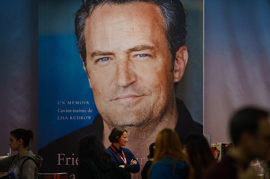 A photo of a gigantic poster of Matthew Perry's memoir at a book launch event