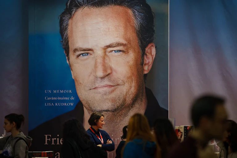 A photo of a gigantic poster of Matthew Perry's memoir at a book launch event