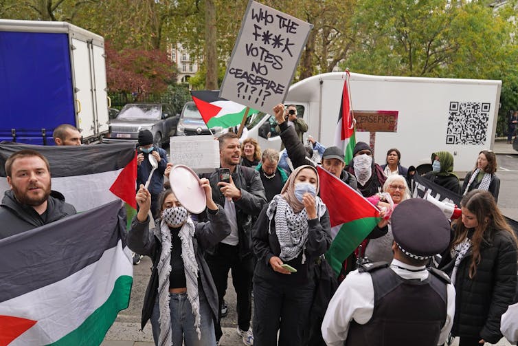 Protestors holding up Palestinian flags.