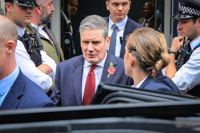 Keir Starmer surrounded by security.