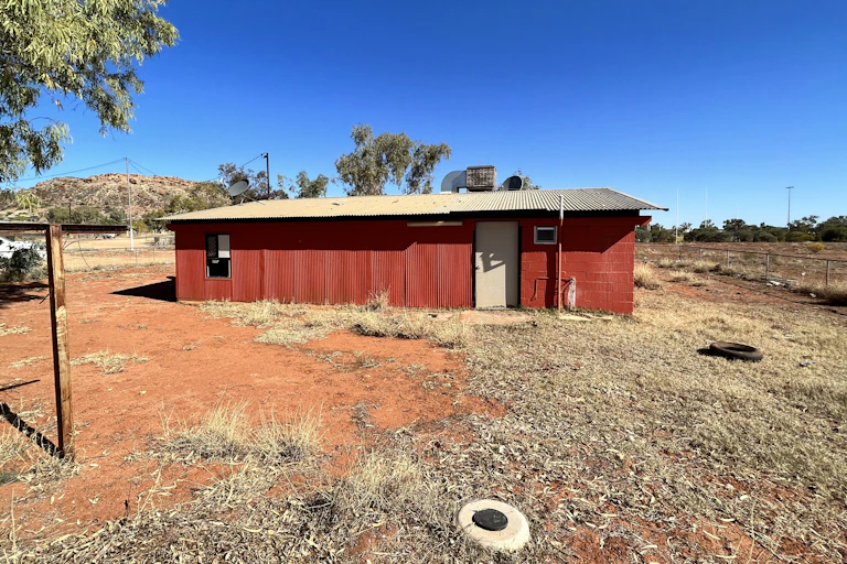 A small corrugated iron house in the Australian outback
