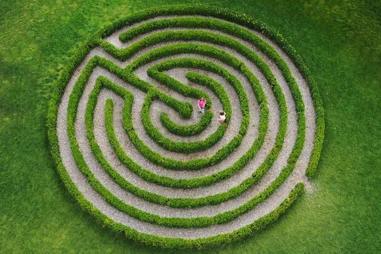 Two children inside a labyrinth.