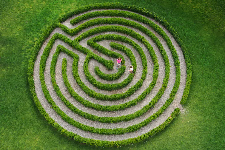 Two children inside a labyrinth.