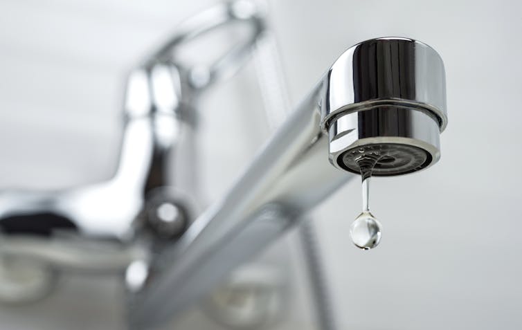 drop of water suspended below tap