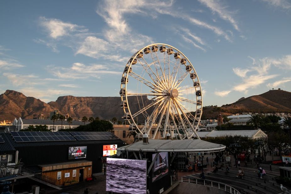 A photograph of Cape Town's distinctive Table Mountain as the backdrop to a large Ferris wheel