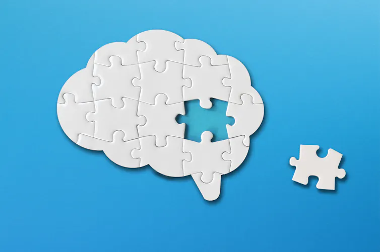 A picture of a brain made our of puzzle pieces. One piece is missing.