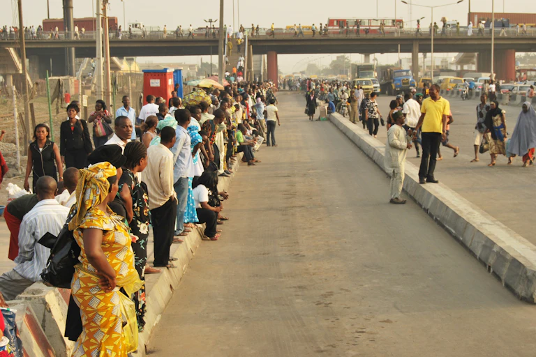A group of people standing at the roadside