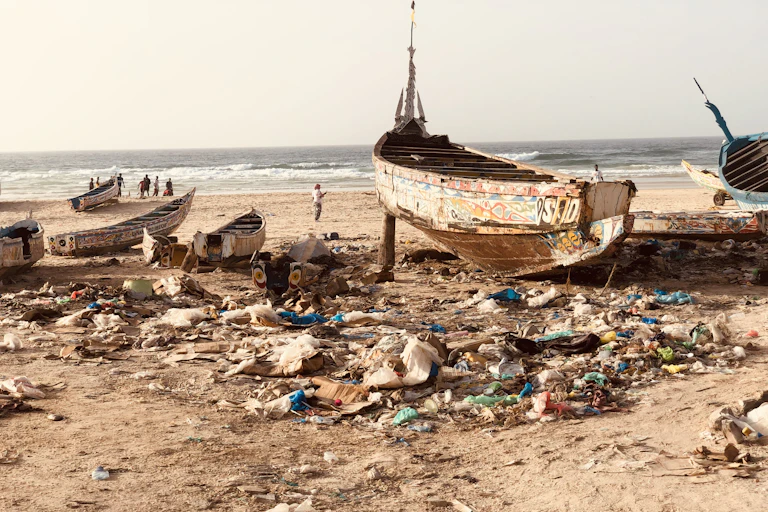 Some boats surrounded by dirt on the beach