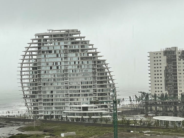 A stormy sky shows through the floors that were once apartments.