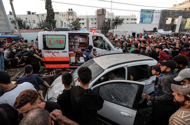 Crowds of Palestinians around an abulance folowing an Israeli airstrike in Gaza, November 3 2023.