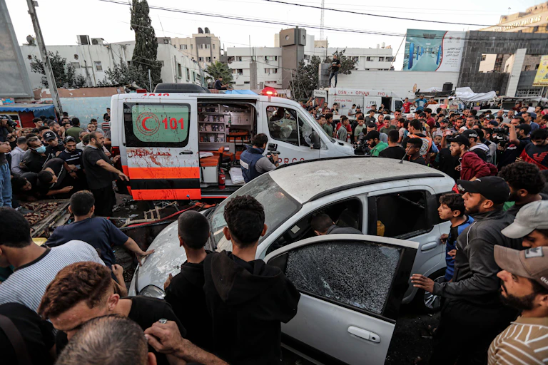 Crowds of Palestinians around an abulance folowing an Israeli airstrike in Gaza, November 3 2023.