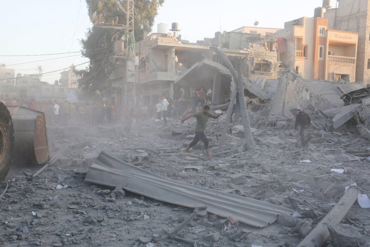 A man searches through rubble after an Israeli strike on the Gaza Strip in Rafah on Monday, November 6 2023.
