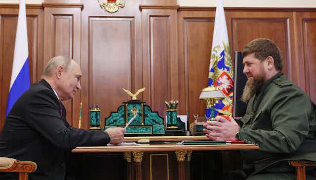 Vladimir Putin and Ramzan Kadyrov sit across from each other