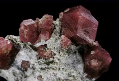 Red mineral cubes embedded in a pale grey rock