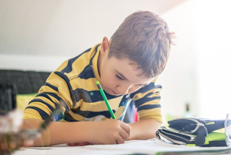 boy at desk doing homework