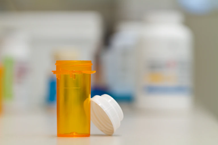 An empty prescription pill vial.