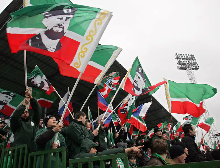 Football fans wave Chechen flags with picture of leader Ramzan Kadyrov