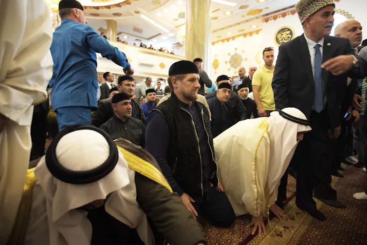 Ramzan Kadyrov kneels inside a mosque