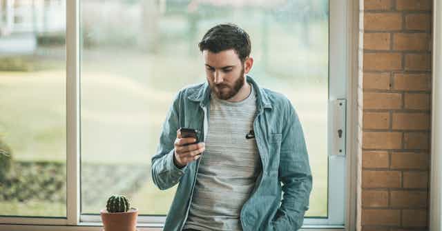 Man looks at his smartphone