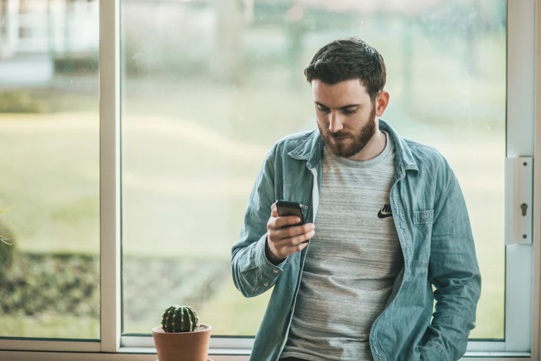 Man looks at his smartphone