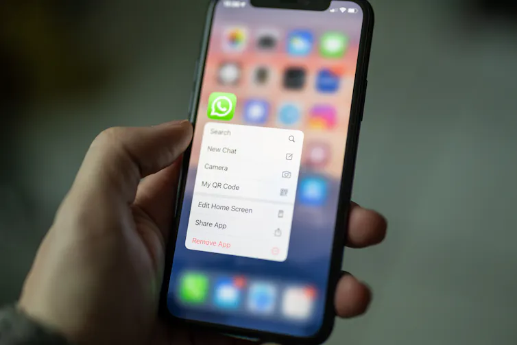 Person opens Whatsapp on their smartphone