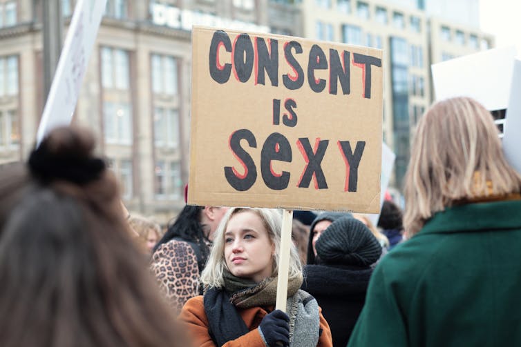A woman carrying a banner reading 'Consent is Sexy'.