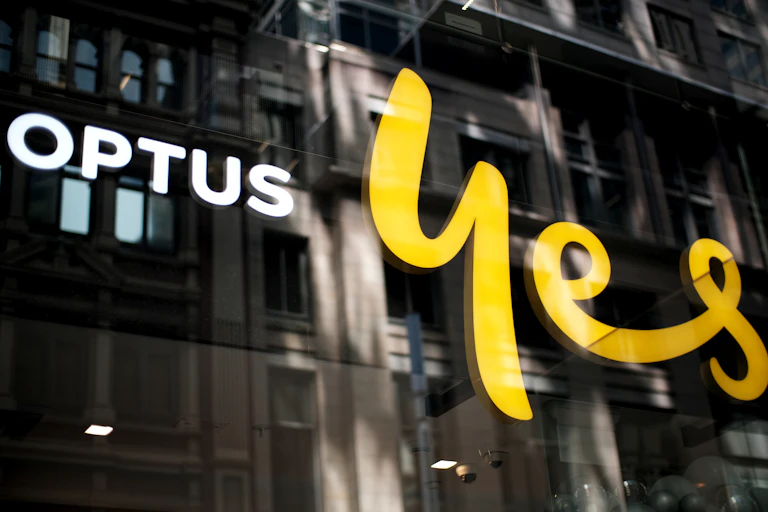 A glass window with Optus logo and the word yes in yellow script
