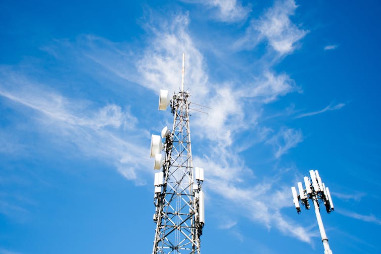 A radio and 5G tower against a blue sky