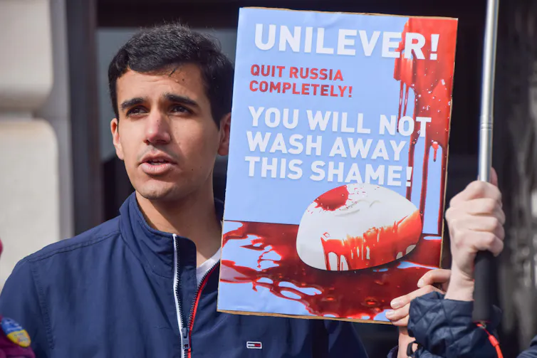 Protester pressuring Unilever to quit Russia soon after the invasion.