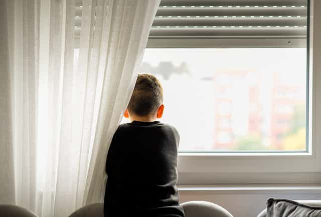 young boy looking out of window