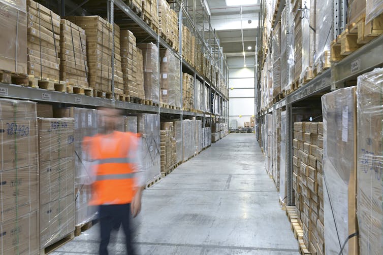 blurred worker in warehouse