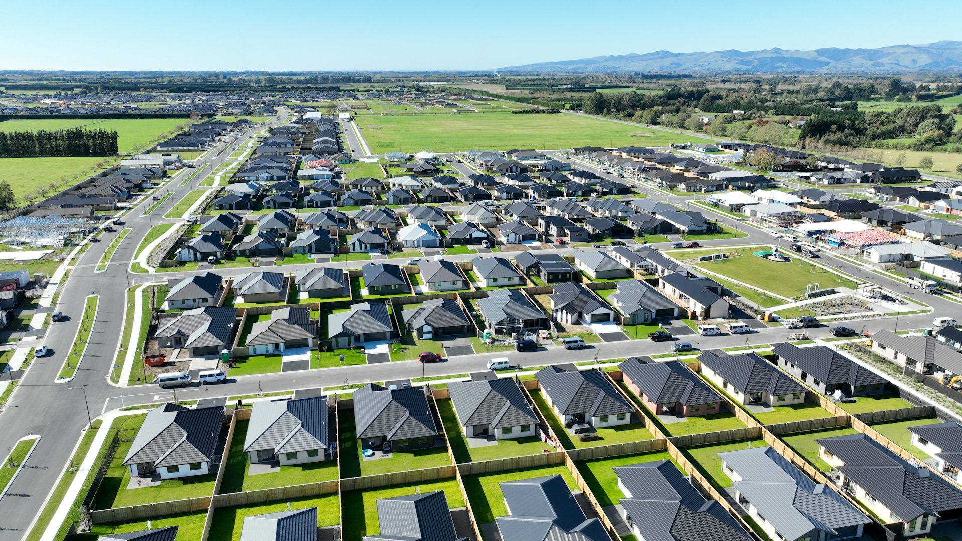 Rows of new houses being built on productive farm land.
