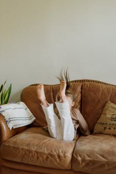 A child jumps on a couch