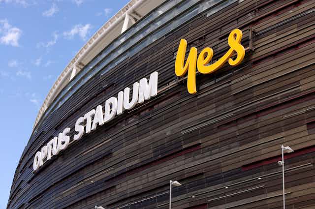 A sign displays the words 'Optus Stadium, Yes'