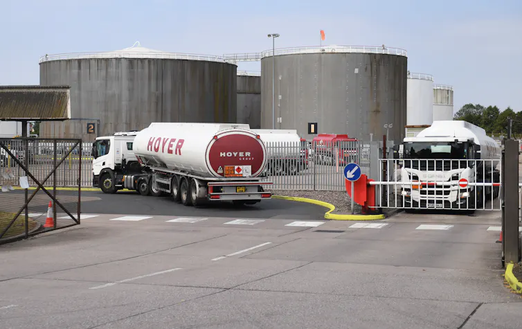 White oil tankers leaving and departing an oil terminal.