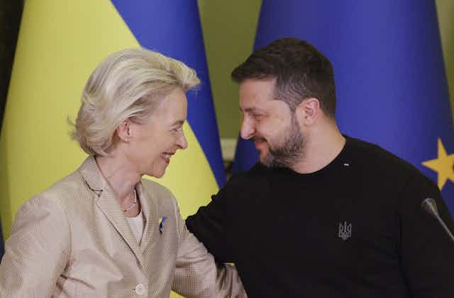 Volodymyr Zelensky and Ursula von der Leyen smile at each other and embrace. 