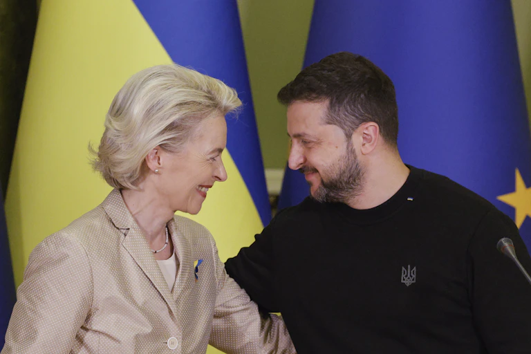 Volodymyr Zelensky and Ursula von der Leyen smile at each other and embrace.
