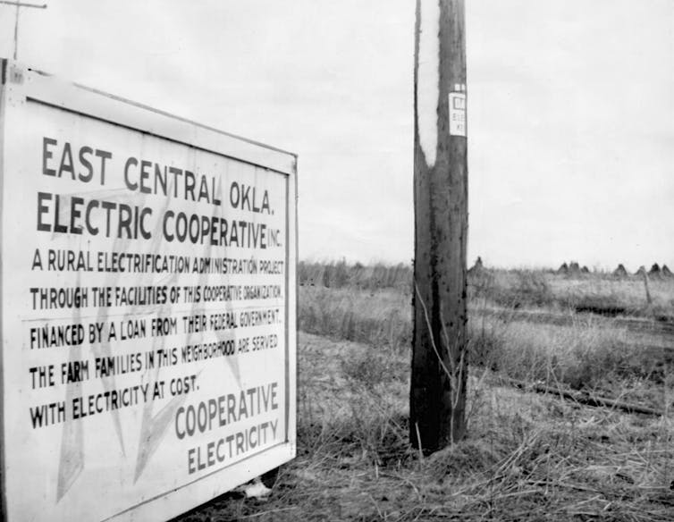 A 1942 sign in east central Oklahoma announces that local power is provided at cost by a cooperative utility.