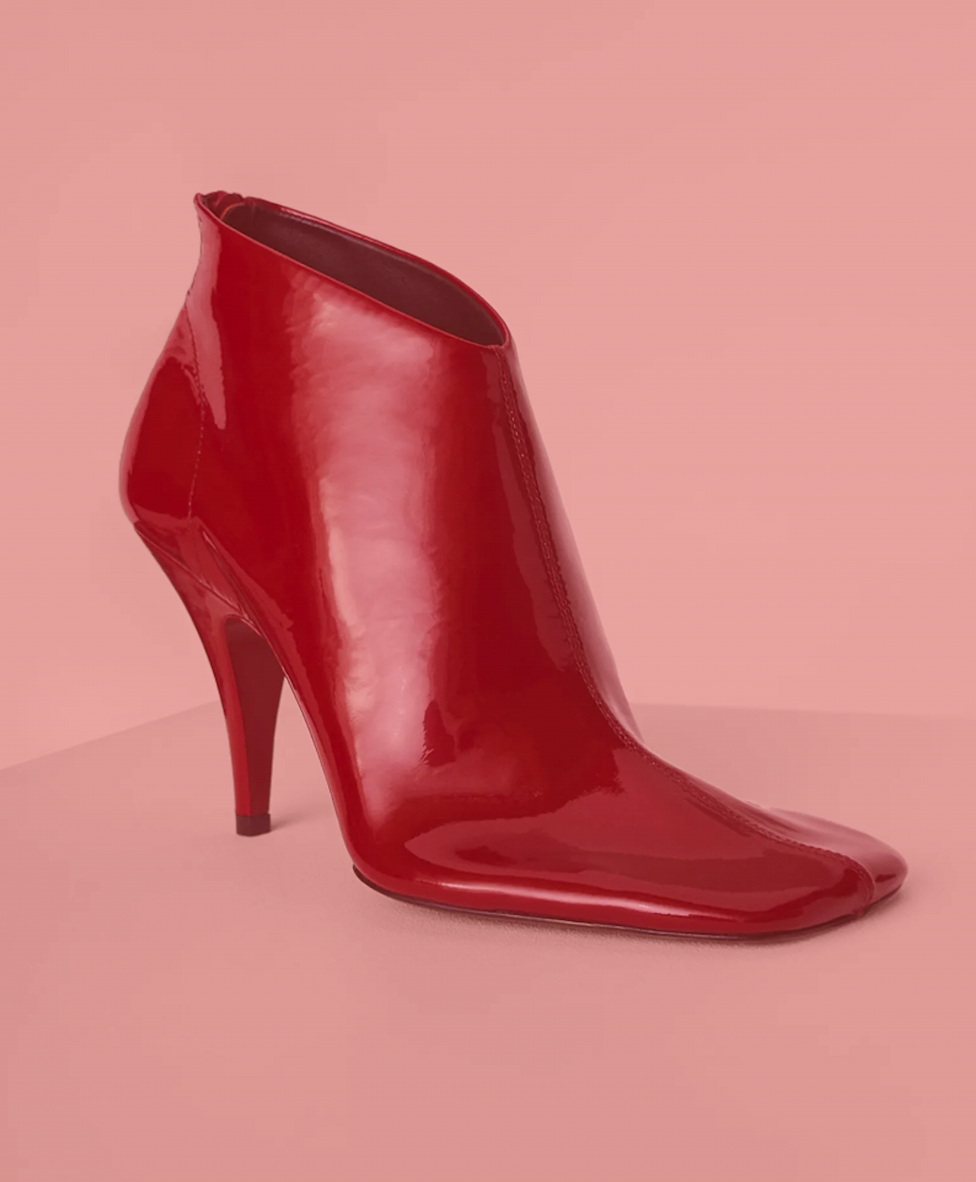 A single red ankle boot with a blunt square toe.