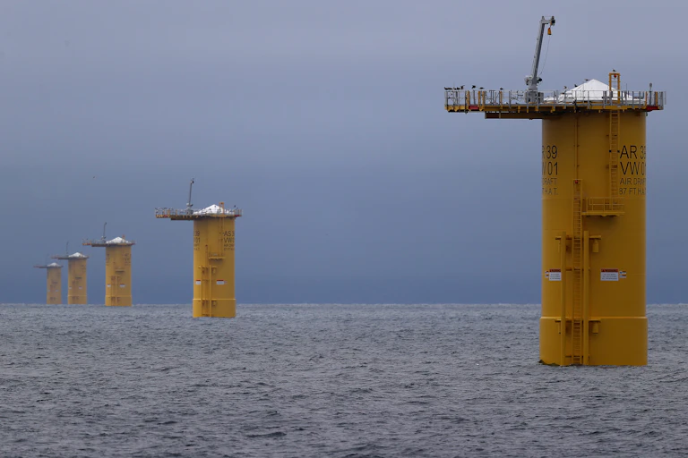 Five round yellow towers stand in open ocean waters