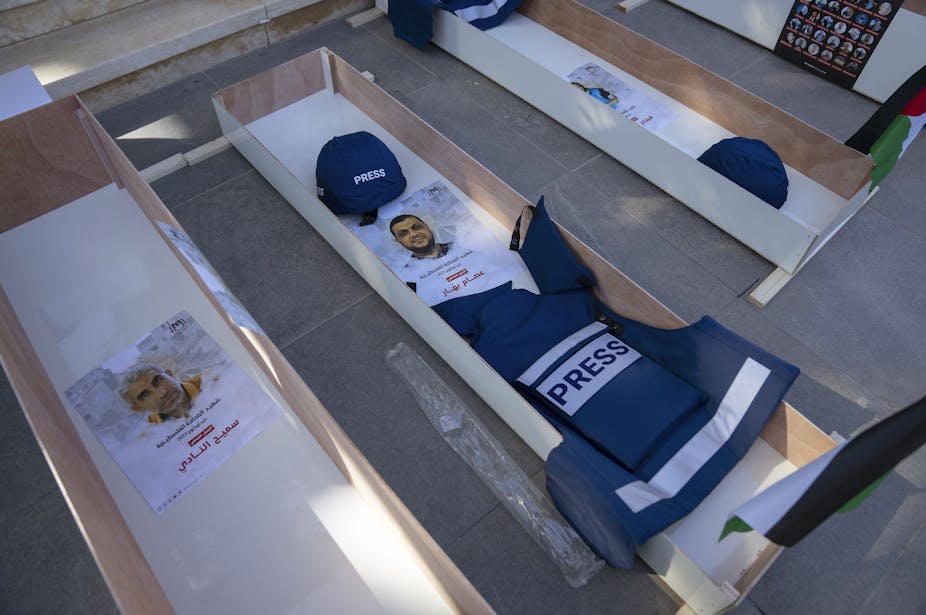 Pictures of people placed in coffins to highlight journalist deaths