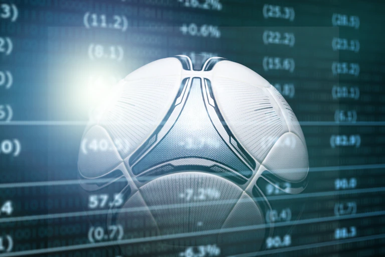 Image of a football on financial screen backdrop.
