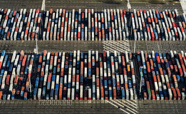 Aerial view of multicoloured shipping containers looking like blocks from the air