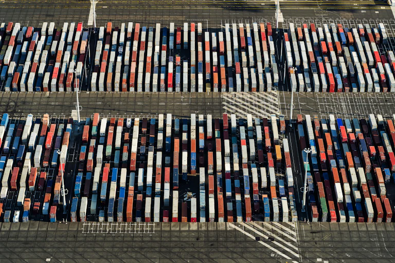Aerial view of multicoloured shipping containers looking like blocks from the air