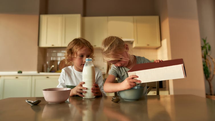 Two children having cereal.